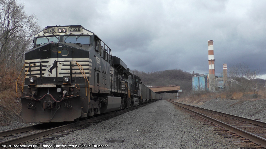 A empty coal train sits tied down on the Mon Line